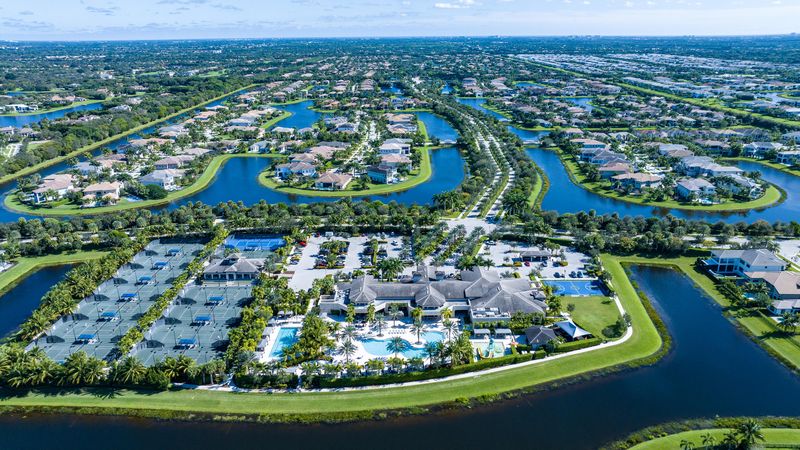 The Seven Bridges clubhouse and amenity center from above, surrounded by lakes and homes